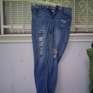 Light blue denim jeans with holes in them